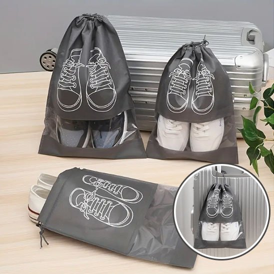 Sac à chaussures en nylon avec motif décoratif, fermé par un cordon élastique, posé sur une surface 